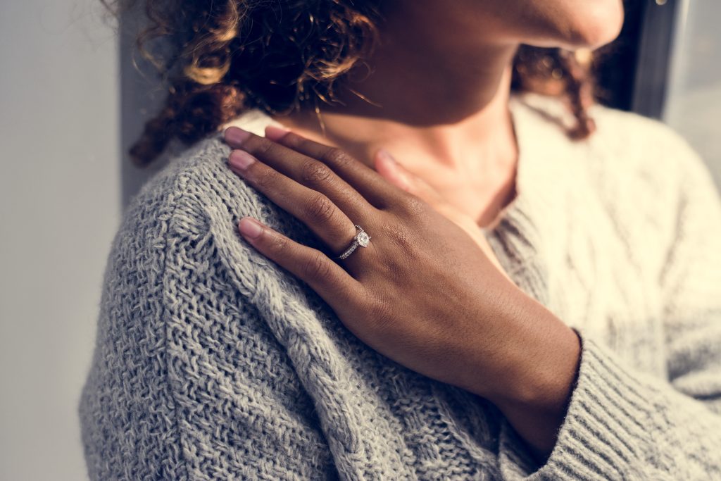 Cheerful woman with engagement ring