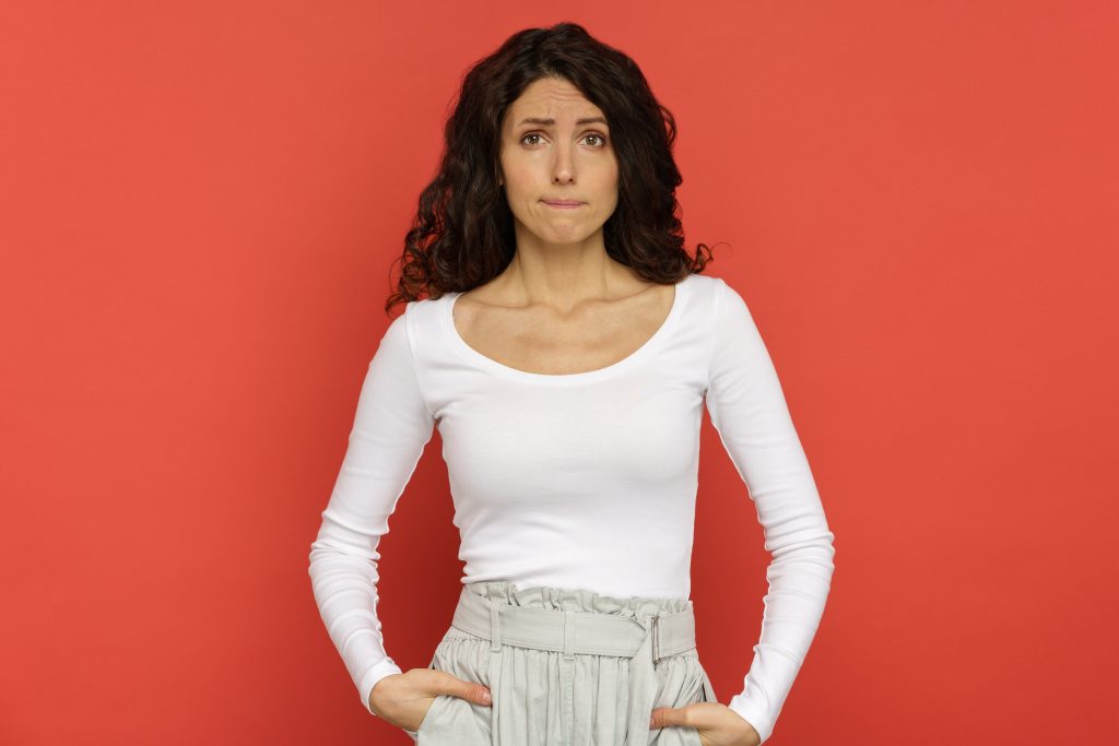 Portrait of grumpy unconfident young woman bite lips with tears in eyes, scared of mistake isolated