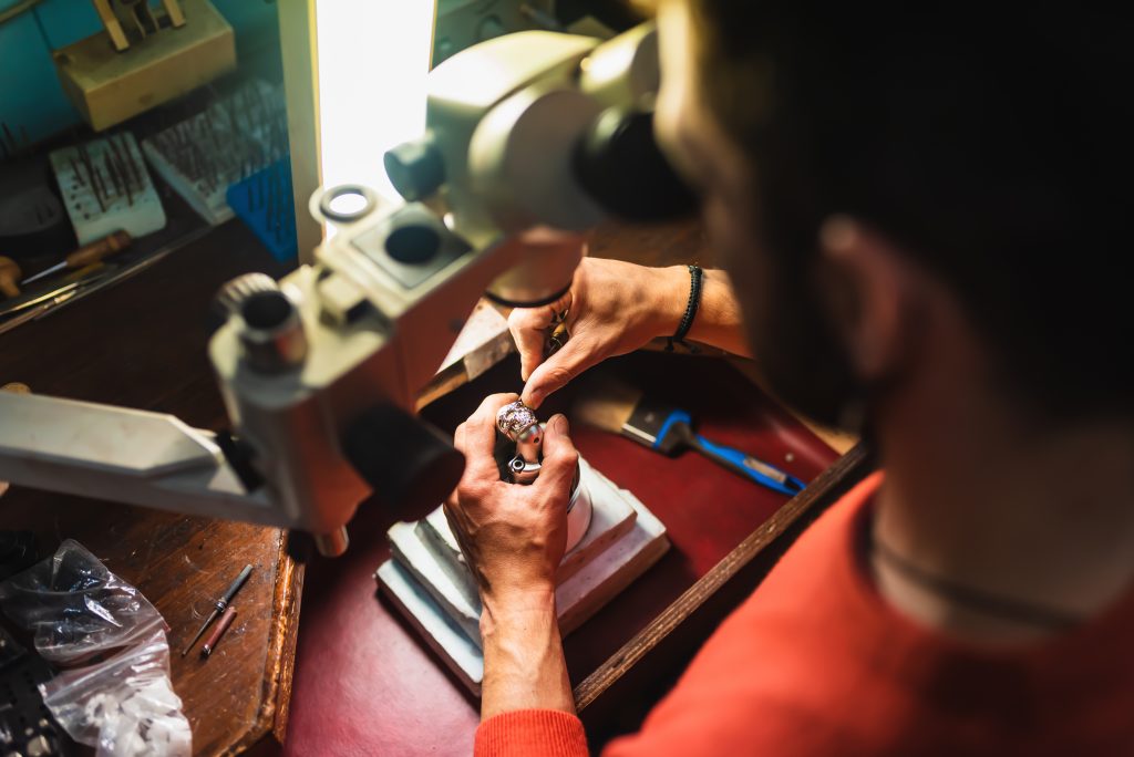 Unrecognizable jeweler hands working on a piece of jewelry