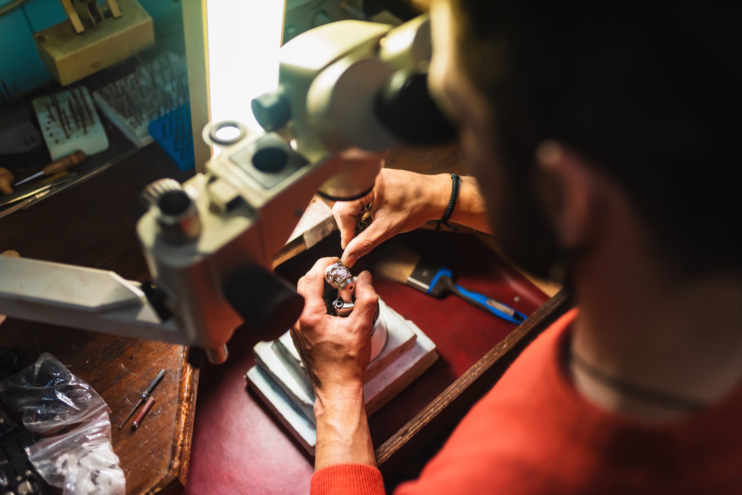Unrecognizable jeweler hands working on a piece of jewelry